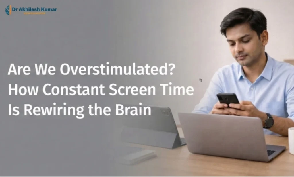 Man using a smartphone while working on a laptop, illustrating how constant screen time may overstimulate the brain, by Dr. Akhilesh Kumar, Neurosurgeon in Lucknow.